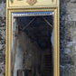 Magnifique miroir trumeau ancien en bois doré. Cadre sculpté, glace biseautée, bas-relief de chérubins.